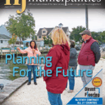 Cover of NJ Municipalities Magazine featuring an image of ‎4 people near a waterfront with a headline that reads, "Planning for the Future."