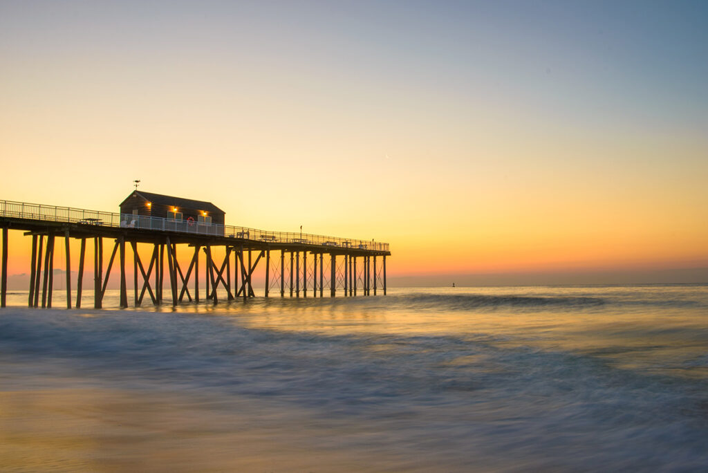 An image of an ocean pier at sundown
