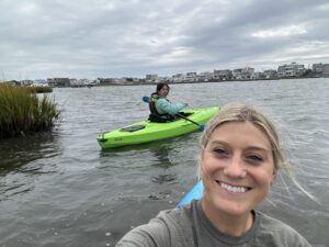 A group kayaks through a marsh area