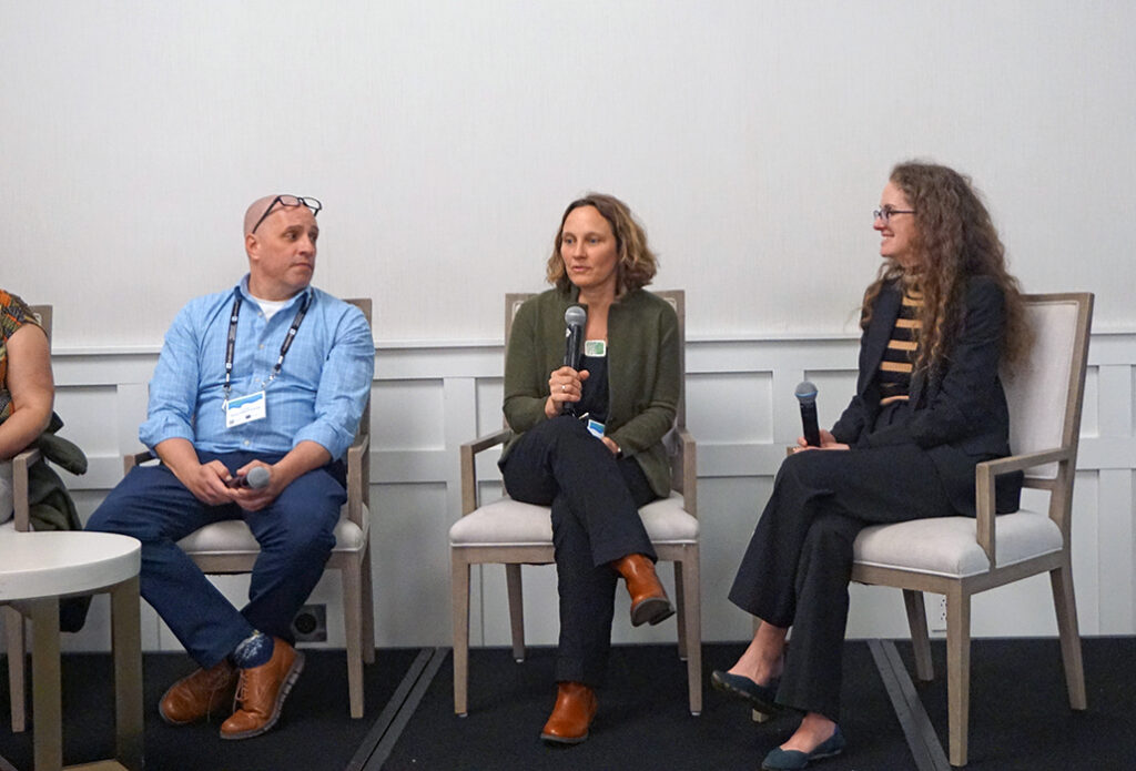 Three seated panelists in discussion